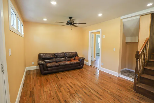 a living room with furniture and a wooden floor