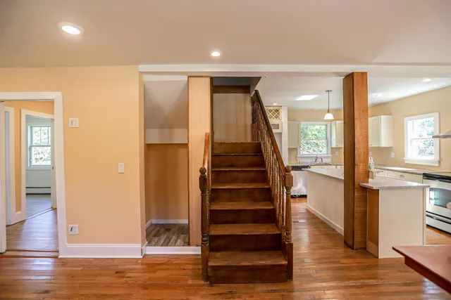 a view of entryway with wooden floor and staircase