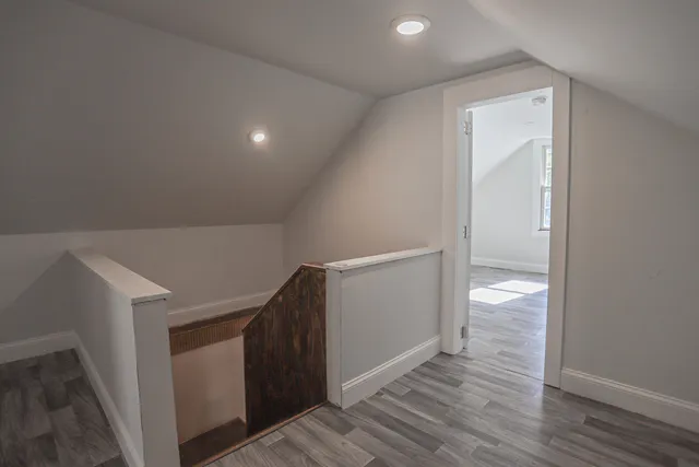 a view of hallway with wooden floor