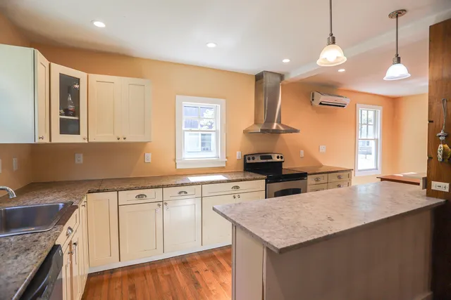 a kitchen with a stove a sink and a refrigerator