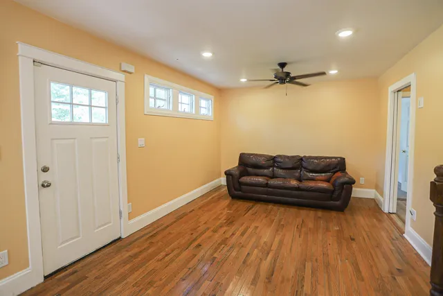 a living room with couch and a wooden floor