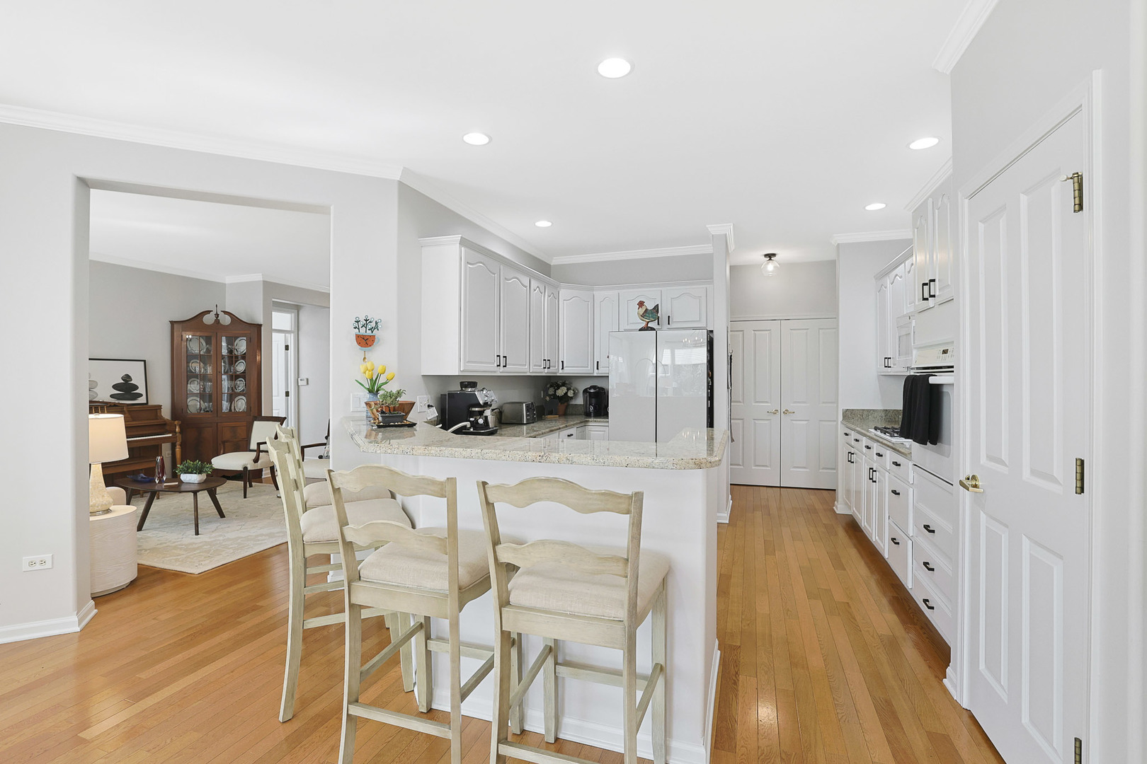 12961 West Bull Ridge Drive Huntley, IL 60142 - Photo 20 of 35 a large white kitchen with lots of counter space dining table and stainless steel appliances