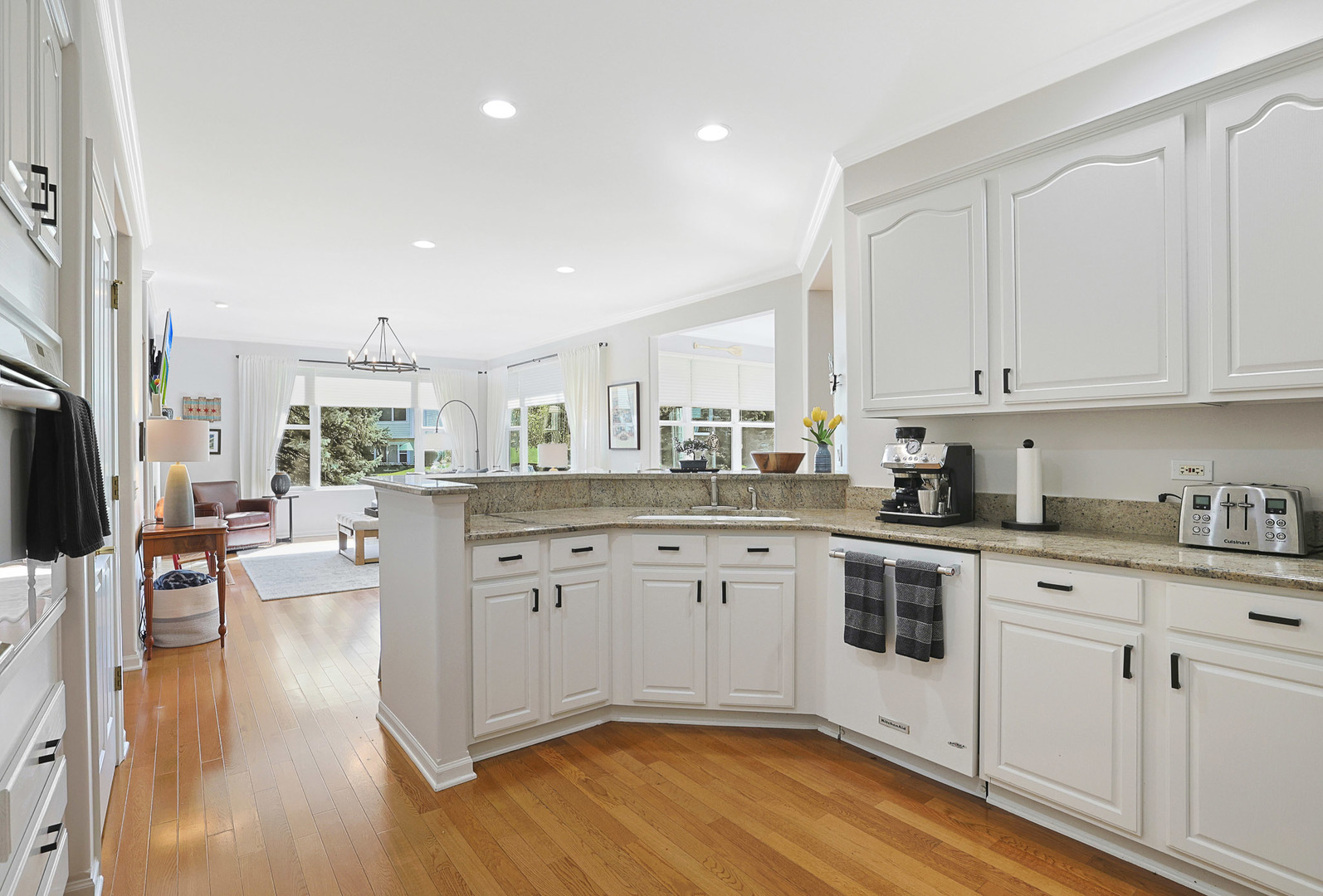12961 West Bull Ridge Drive Huntley, IL 60142 - Photo 23 of 35 a kitchen with granite countertop white cabinets and white appliances