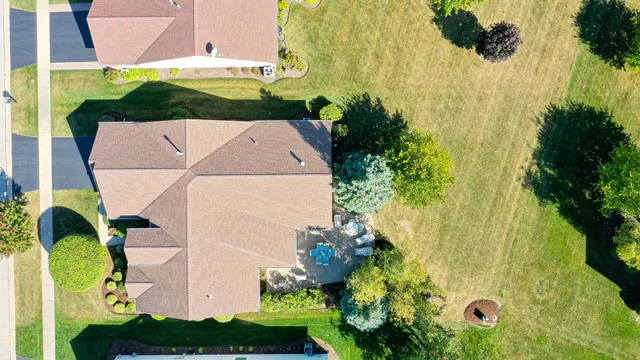 an aerial view of a house with a yard