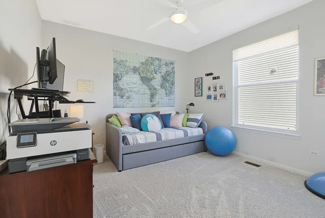 a living room with furniture a flat screen tv and a window