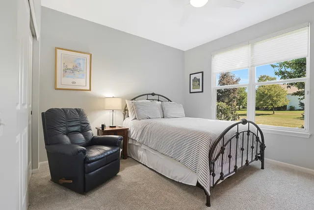 a bed sitting in a bedroom next to a window