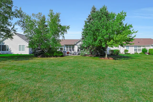 a view of an house with backyard space and balcony