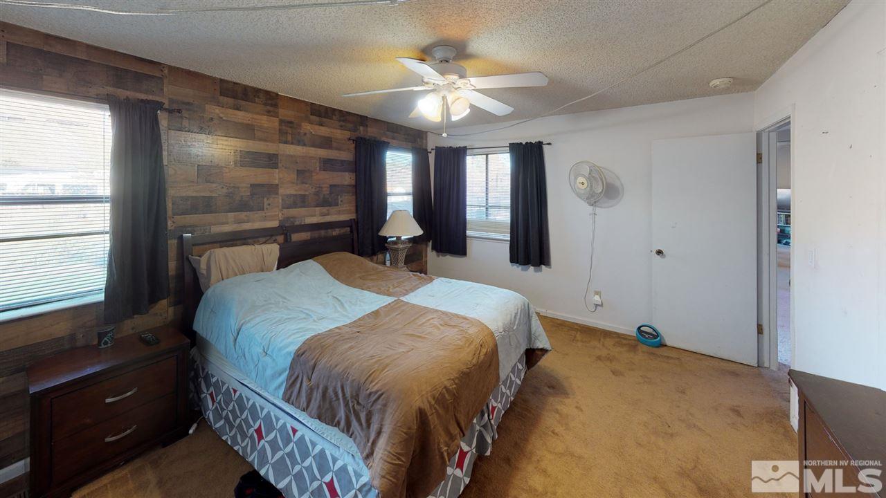 285 Gooseberry Drive Reno, NV 89523 - Photo 11 of 24 a bedroom with a large bed and a chandelier
