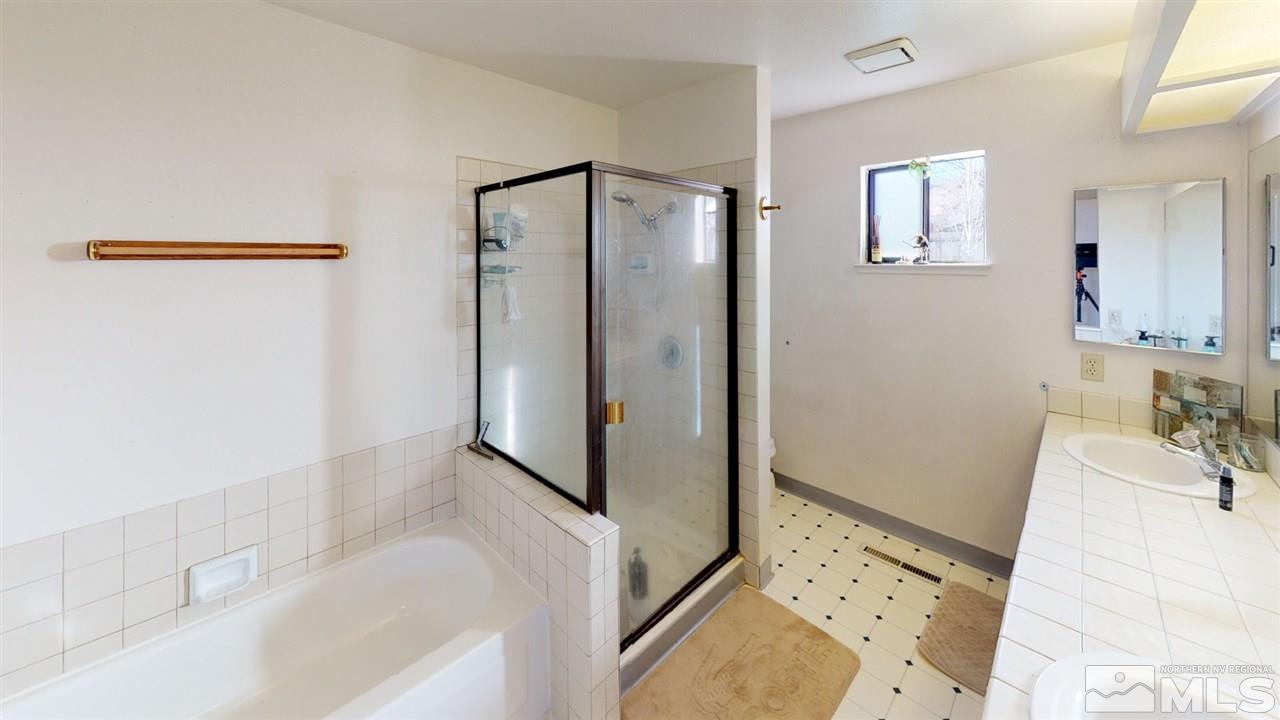 285 Gooseberry Drive Reno, NV 89523 - Photo 12 of 24 a bathroom with a bathtub sink and mirror
