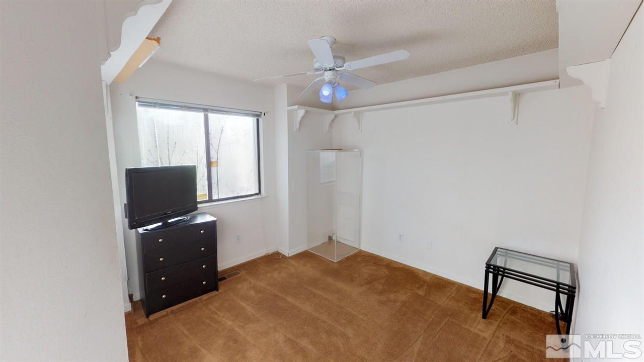 285 Gooseberry Drive Reno, NV 89523 - Photo 13 of 24 a bedroom with a bed and a flat screen tv