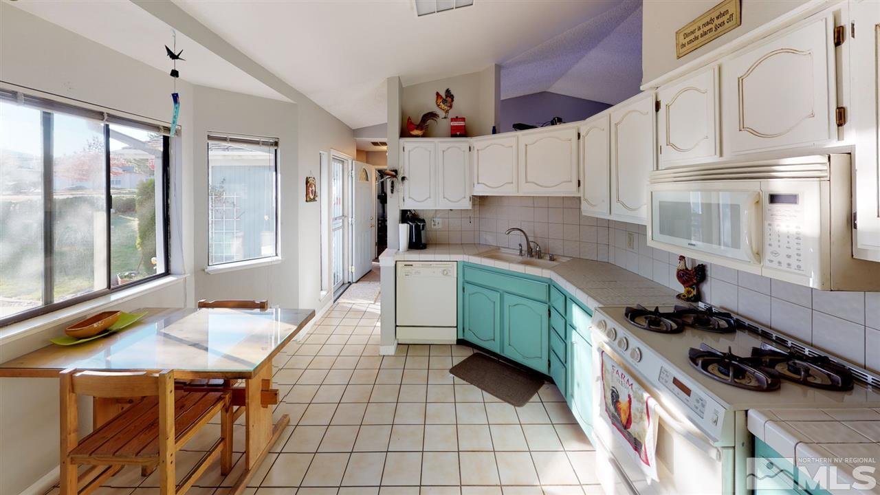 285 Gooseberry Drive Reno, NV 89523 - Photo 4 of 24 a kitchen with stainless steel appliances a stove a sink and a refrigerator