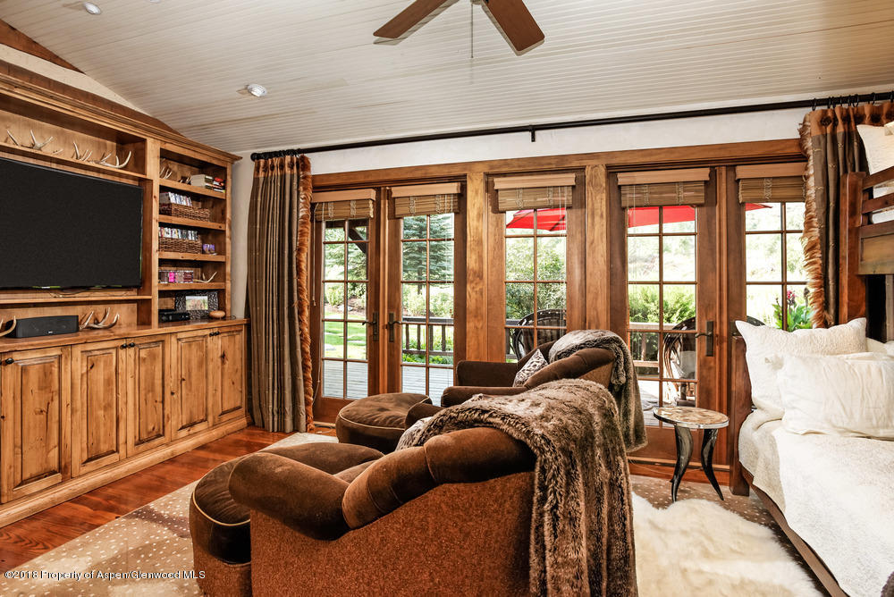 27 Altamira Ranch Road Basalt, CO 81621 - Photo 11 of 22 a living room with furniture a flat screen tv and a floor to ceiling window