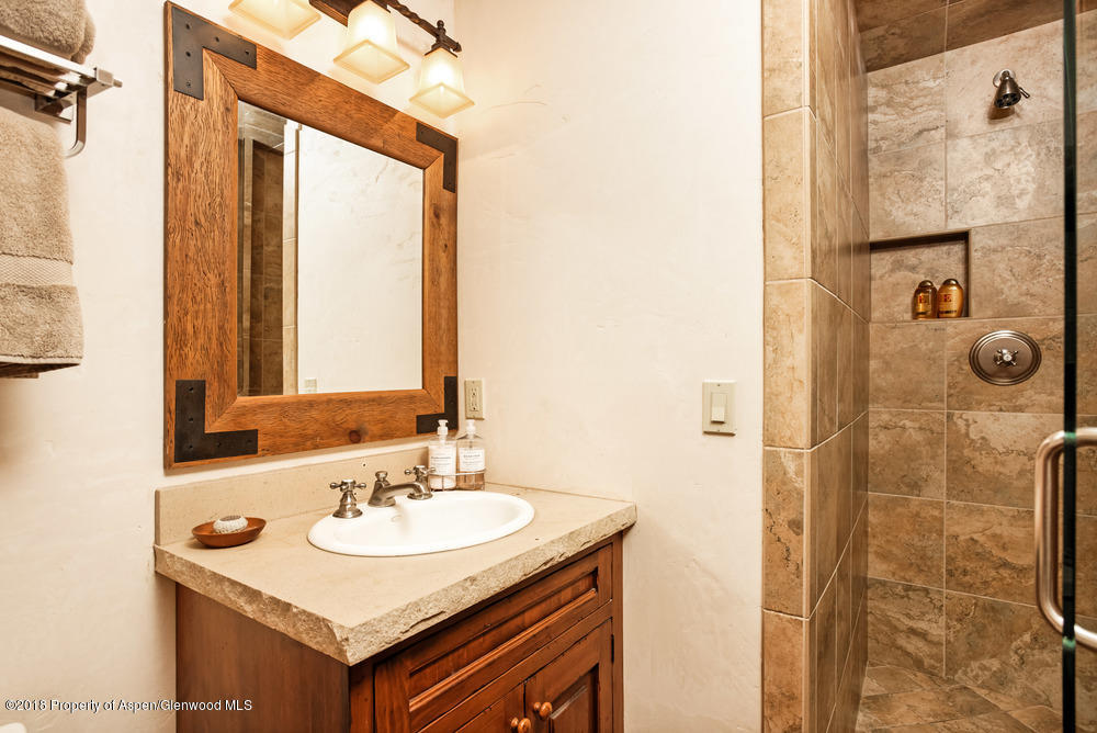 27 Altamira Ranch Road Basalt, CO 81621 - Photo 12 of 22 a bathroom with a sink vanity granite shower and a mirror