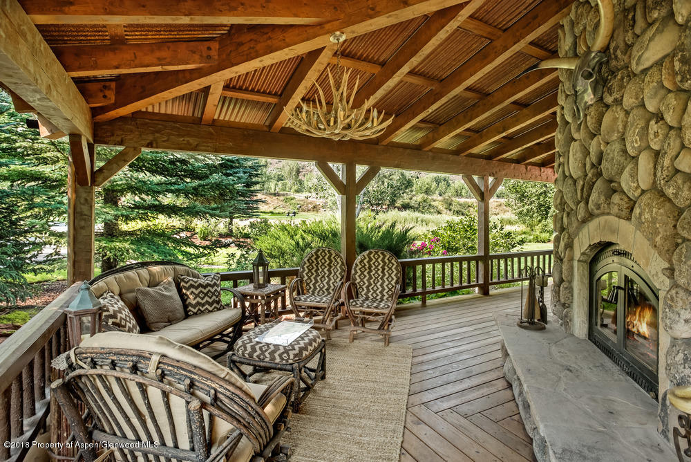 27 Altamira Ranch Road Basalt, CO 81621 - Photo 14 of 22 a view of a porch with furniture and wooden deck