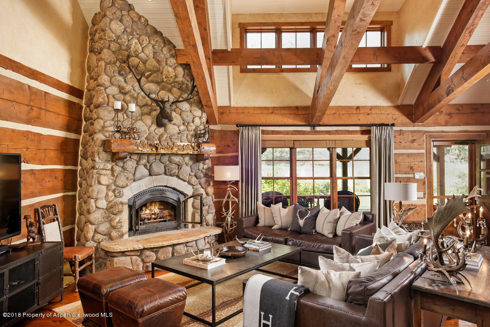 27 Altamira Ranch Road Basalt, CO 81621 - Photo 2 of 22 a living room with furniture a fireplace and a flat screen tv