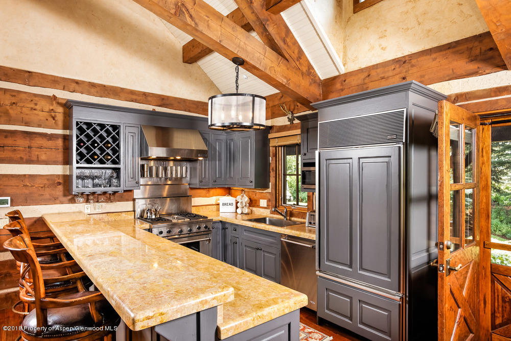 27 Altamira Ranch Road Basalt, CO 81621 - Photo 5 of 22 a kitchen with stainless steel appliances kitchen island granite countertop a refrigerator and stove