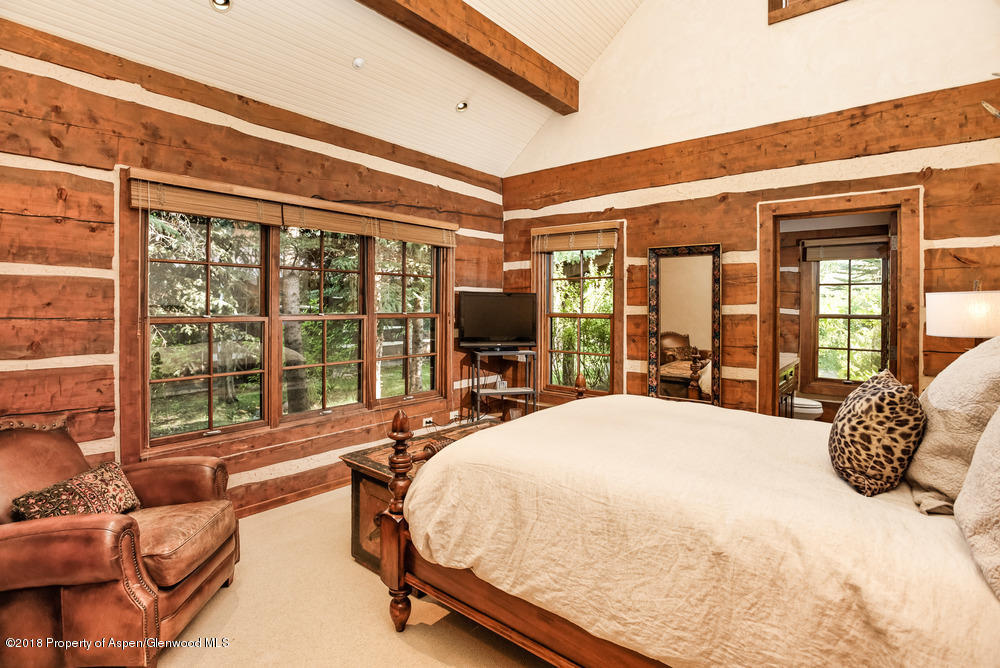 27 Altamira Ranch Road Basalt, CO 81621 - Photo 8 of 22 a large bedroom with a large bed and a large window