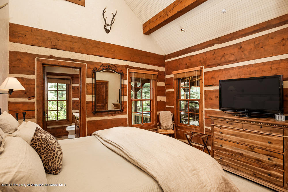 27 Altamira Ranch Road Basalt, CO 81621 - Photo 9 of 22 a bedroom with a bed and a flat screen tv