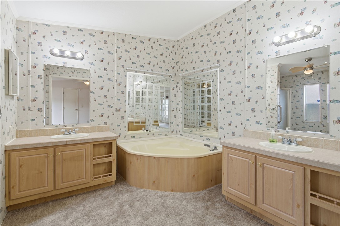 4619 North Lookout Canyon Road Kingman, AZ 86401 - Photo 18 of 50 a bathroom with a double vanity sink mirror and bathtub