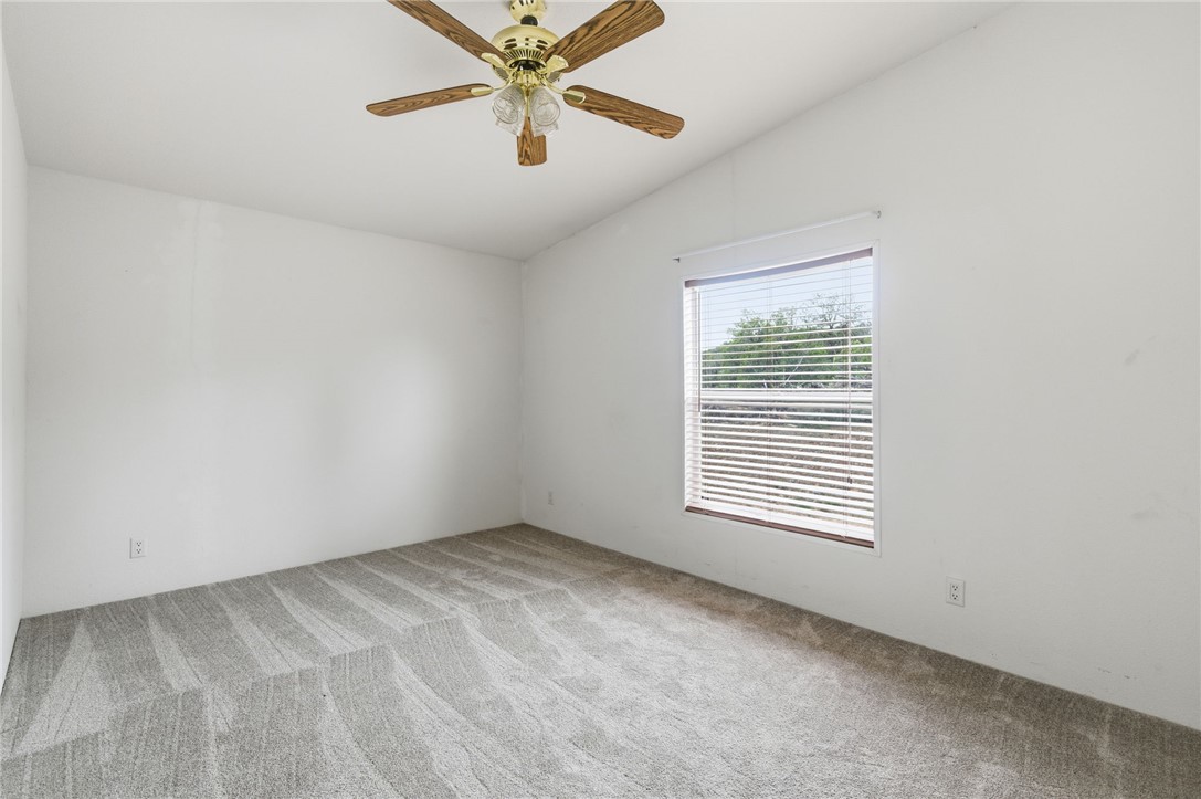 4619 North Lookout Canyon Road Kingman, AZ 86401 - Photo 23 of 50 an empty room with a window and a fan