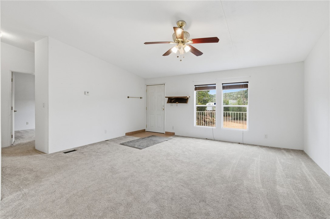4619 North Lookout Canyon Road Kingman, AZ 86401 - Photo 8 of 50 an empty room with windows and fan