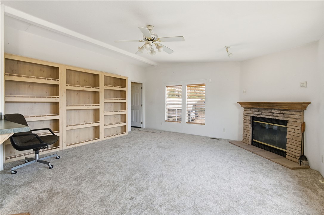 4619 North Lookout Canyon Road Kingman, AZ 86401 - Photo 9 of 50 a view of an empty room with a fireplace and a window