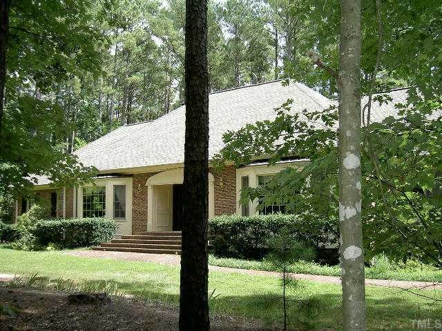602 Neodak Road Apex, NC 27523 - Photo 1 of 12 It's hard to take a photo to do this home justice. Imagine a forest of trees between the road and the home with a winding drive to the side entry garage.