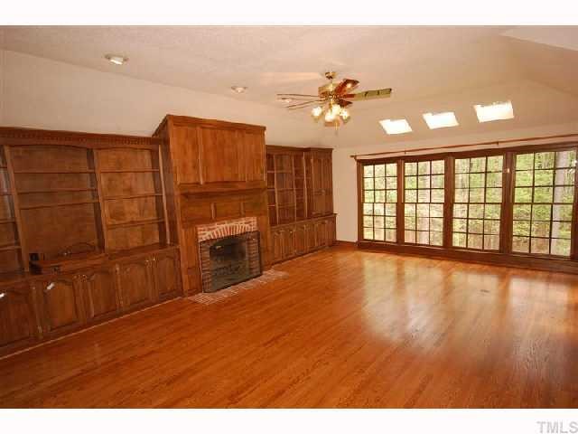 602 Neodak Road Apex, NC 27523 - Photo 7 of 12 You'll love the full wall of built-ins flanking the masonry fireplace.