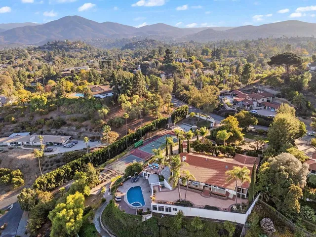 a view of a house with a yard and potted plants