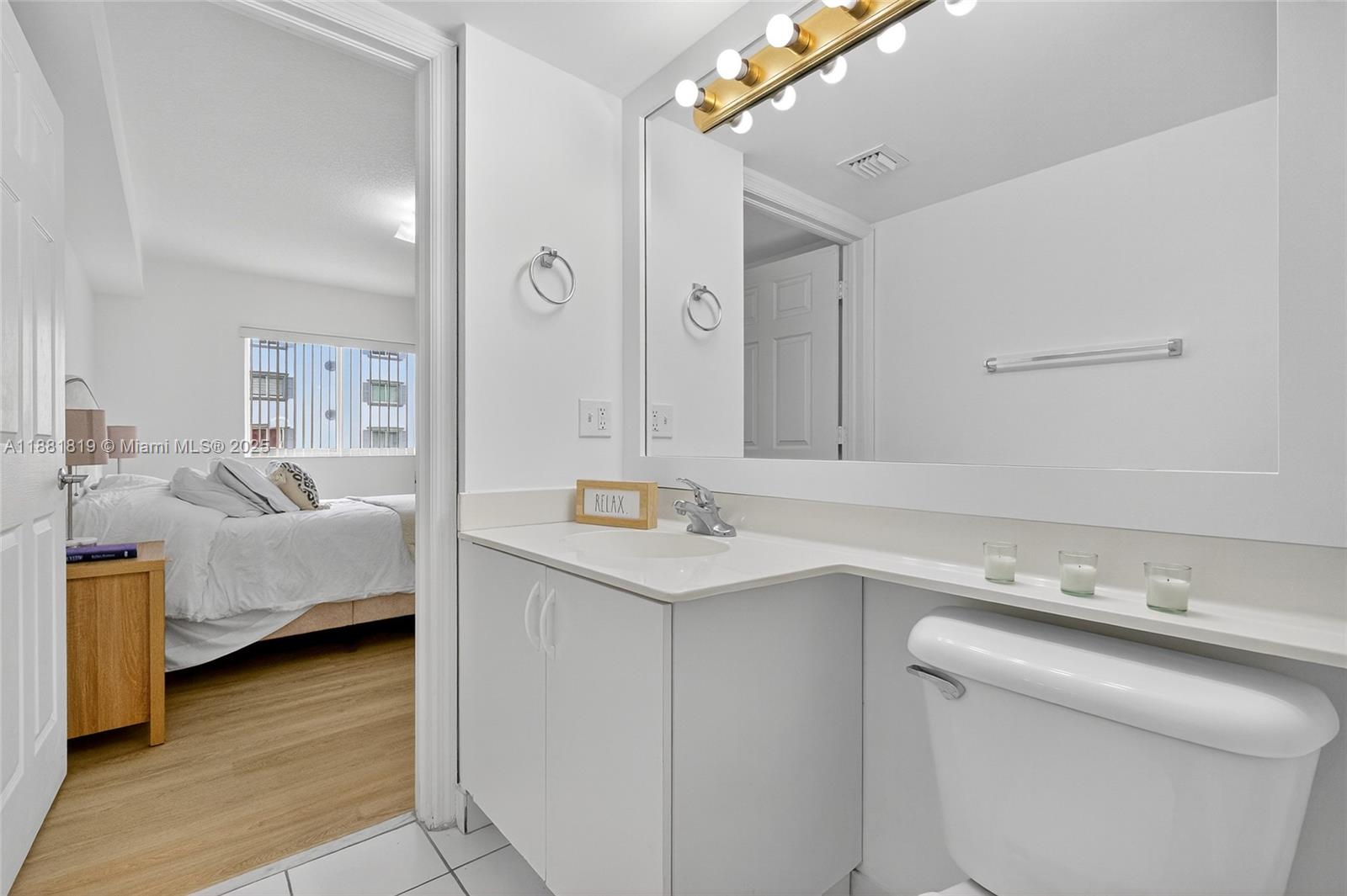 2475 Northwest 16th St Road, Unit 308 Miami, FL 33125 - Photo 11 of 25 a en suite bathroom with a sink and a mirror