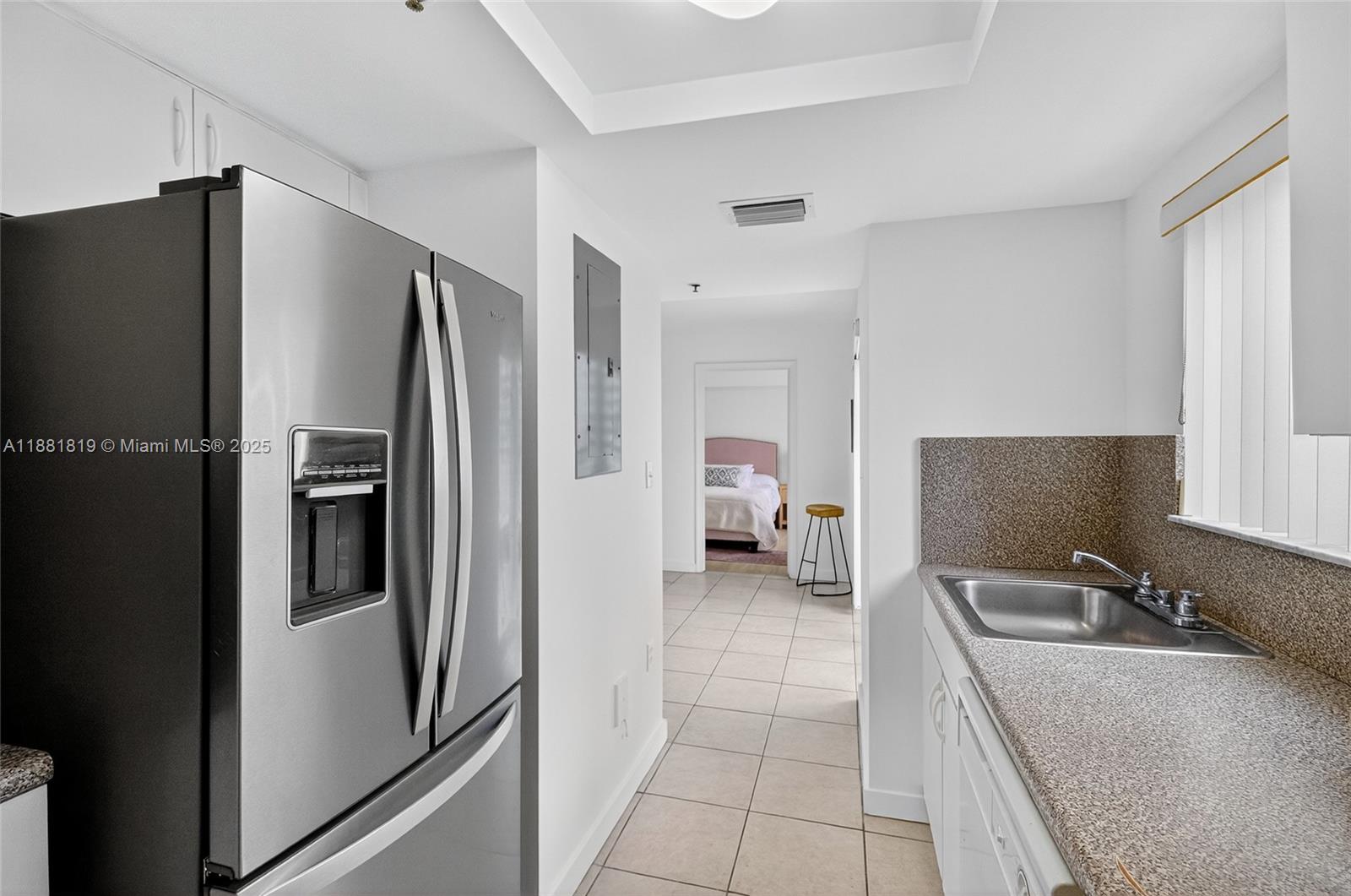 2475 Northwest 16th St Road, Unit 308 Miami, FL 33125 - Photo 14 of 25 a kitchen with stainless steel appliances granite countertop a refrigerator and a sink