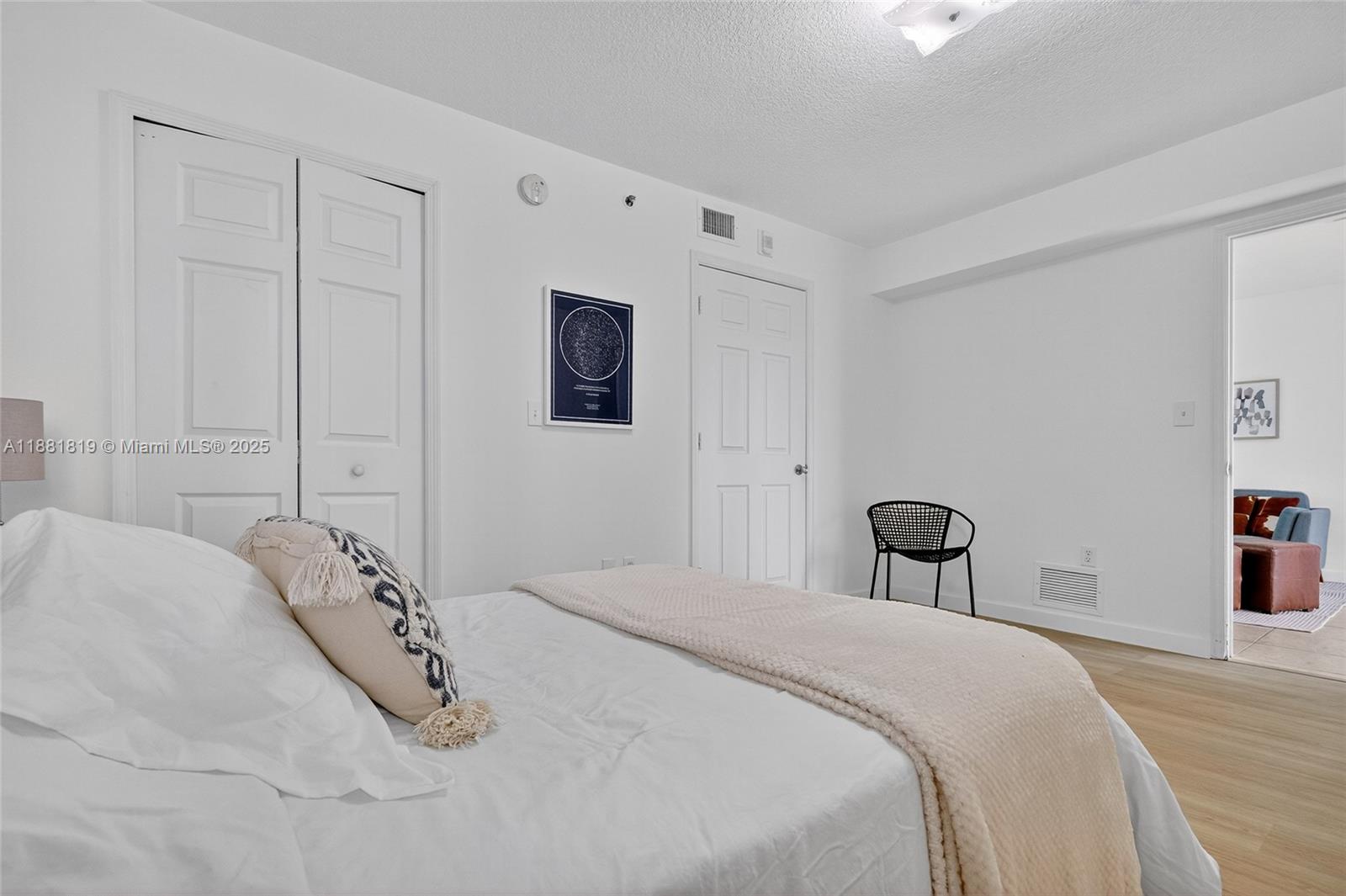 2475 Northwest 16th St Road, Unit 308 Miami, FL 33125 - Photo 17 of 25 a bedroom with a bed and a desk