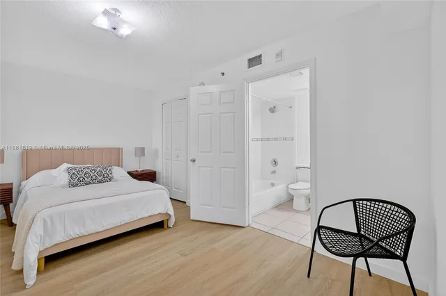 a bedroom with a bed and a chair