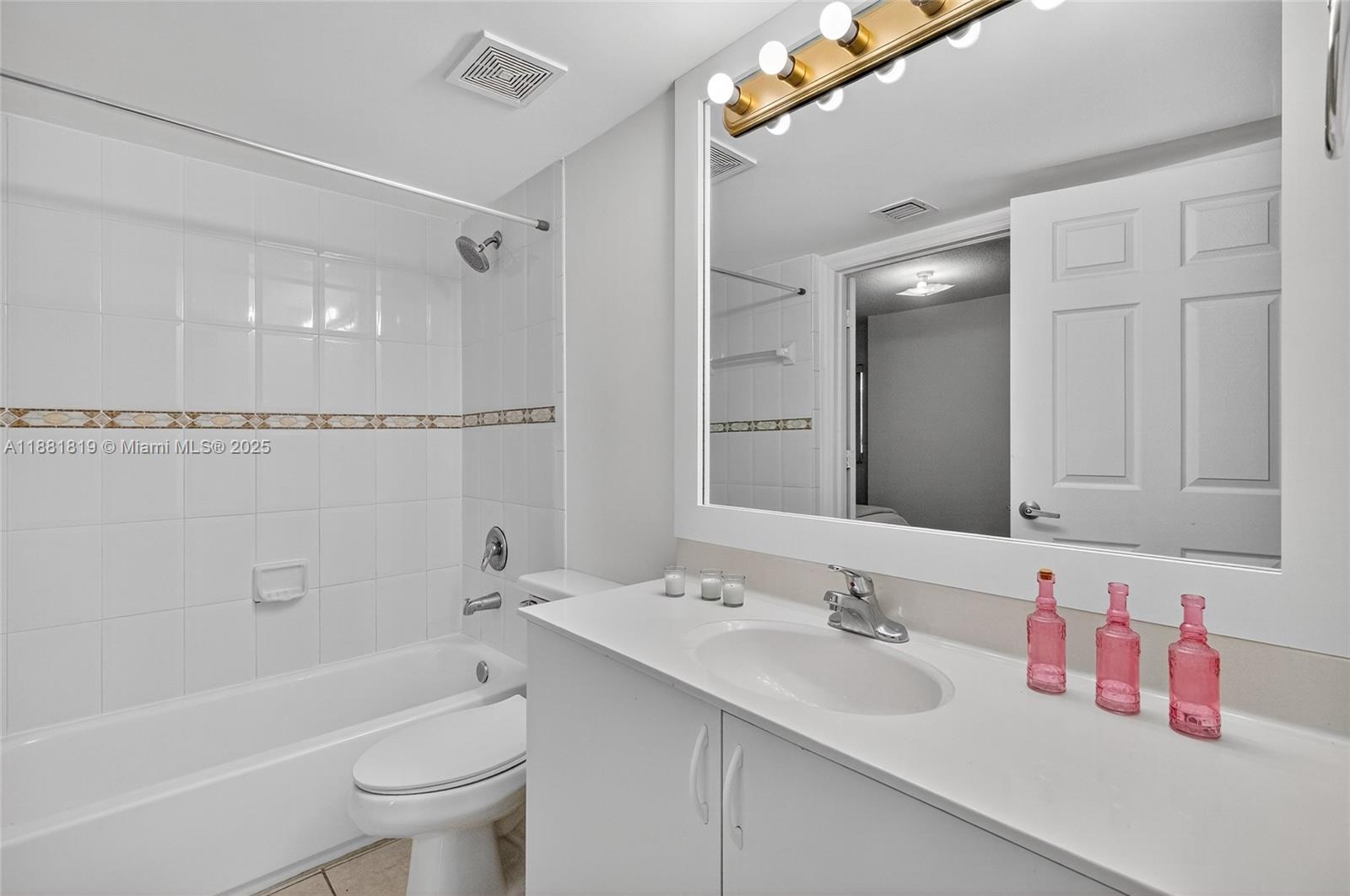 2475 Northwest 16th St Road, Unit 308 Miami, FL 33125 - Photo 19 of 25 a bathroom with a sink and a mirror