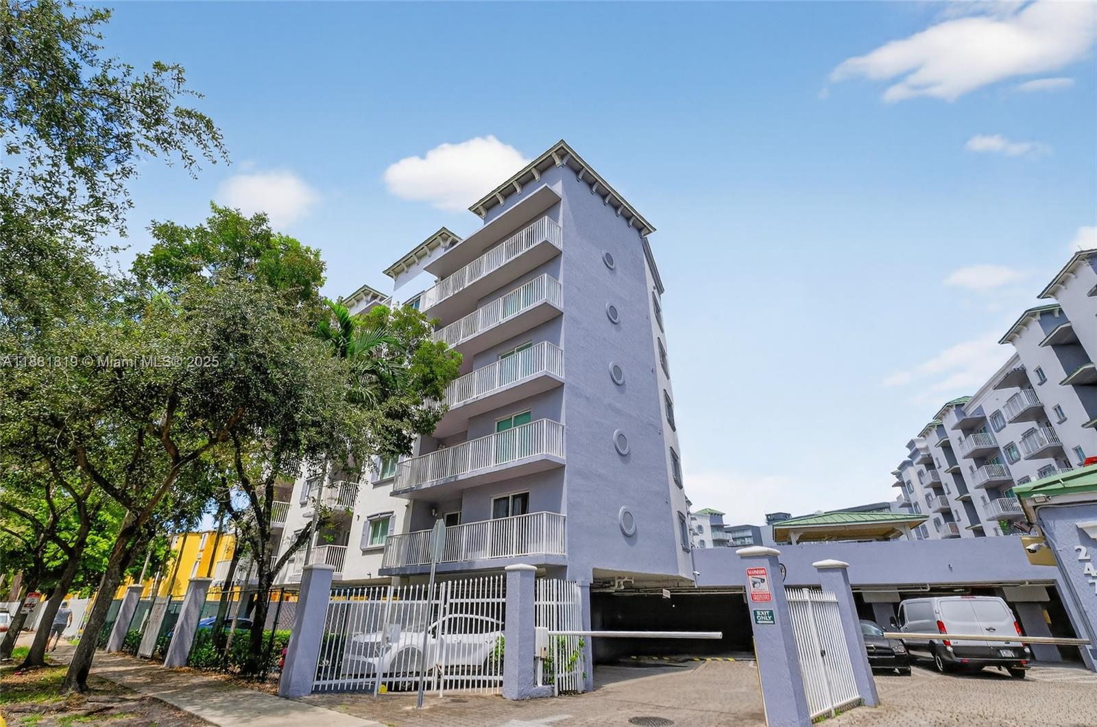 2475 Northwest 16th St Road, Unit 308 Miami, FL 33125 - Photo 22 of 25 a view of a city street lined with buildings and trees