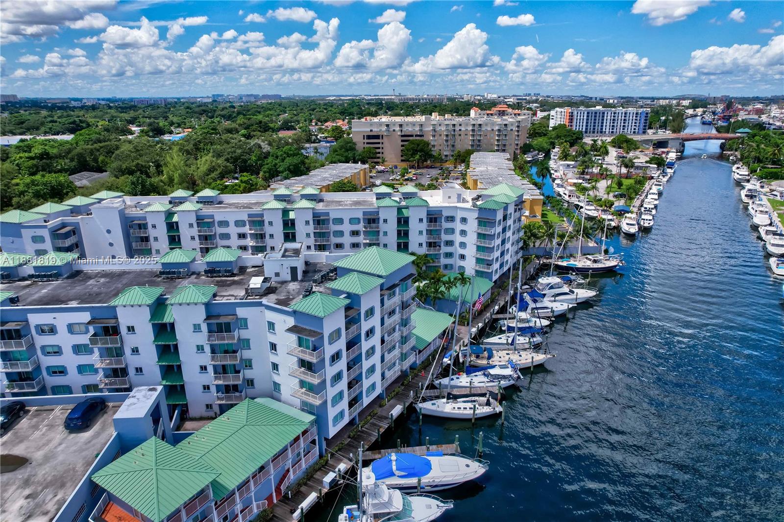 2475 Northwest 16th St Road, Unit 308 Miami, FL 33125 - Photo 23 of 25 a view of a chairs and table in the patio