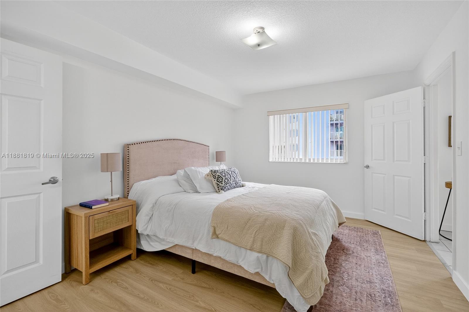 2475 Northwest 16th St Road, Unit 308 Miami, FL 33125 - Photo 7 of 25 a bedroom with a bed and a window