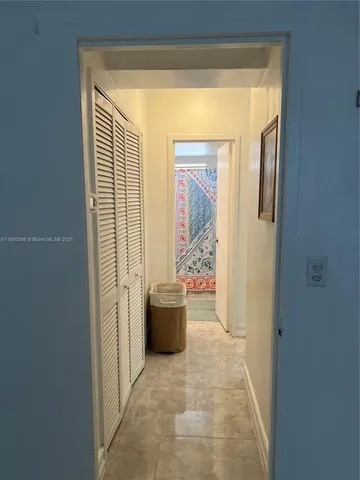 a view of a hallway and a dining room with a door