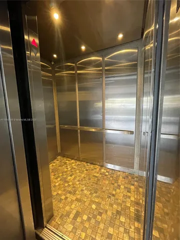 a room with walk in closet and wooden floor