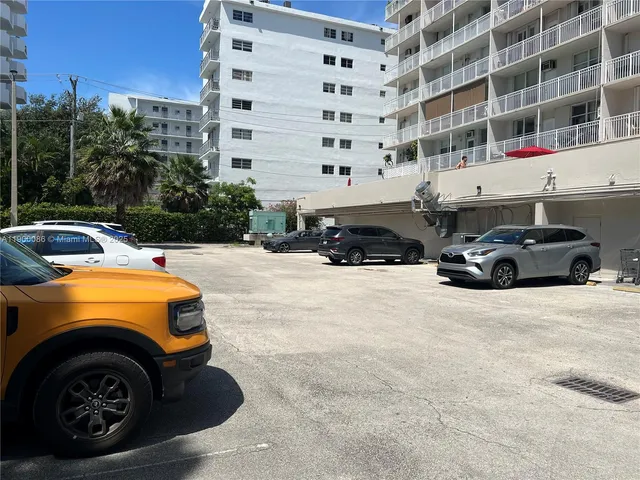 a front view of a building with parking space