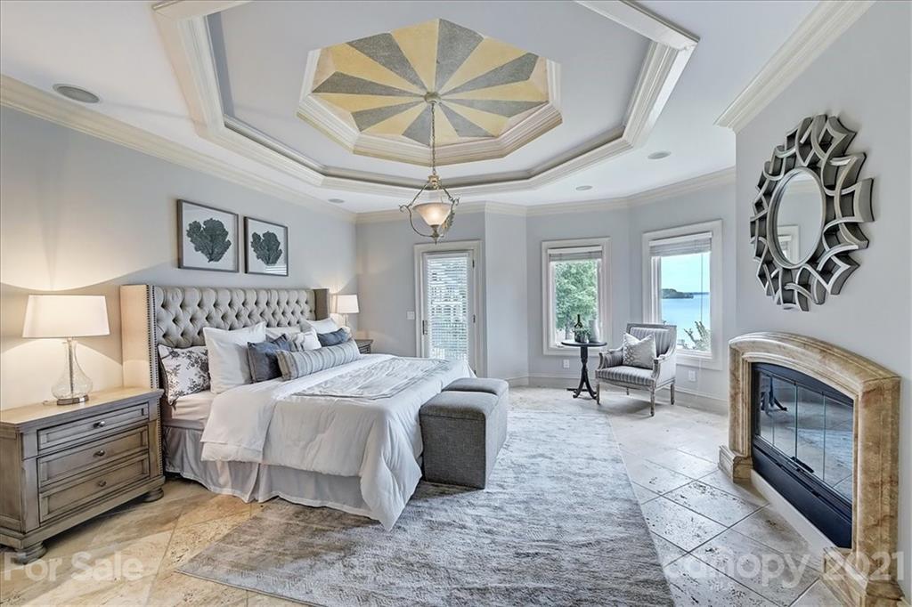 17519 Jetton Road, Unit 390 Cornelius, NC 28031 - Photo 11 of 31 a bedroom with a large bed and a chandelier