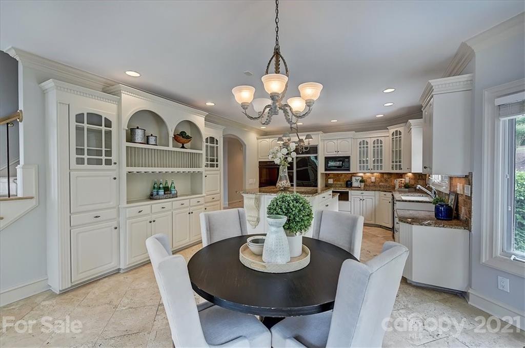 17519 Jetton Road, Unit 390 Cornelius, NC 28031 - Photo 15 of 31 a view of a dining room with furniture and a kitchen