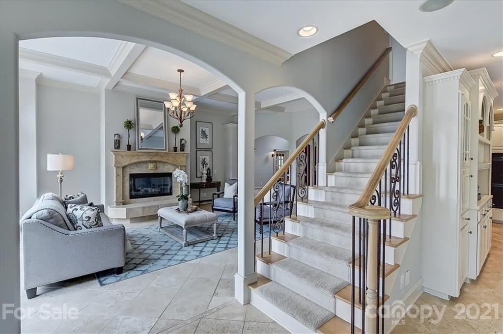 17519 Jetton Road, Unit 390 Cornelius, NC 28031 - Photo 17 of 31 a living room with furniture a fireplace and a chandelier