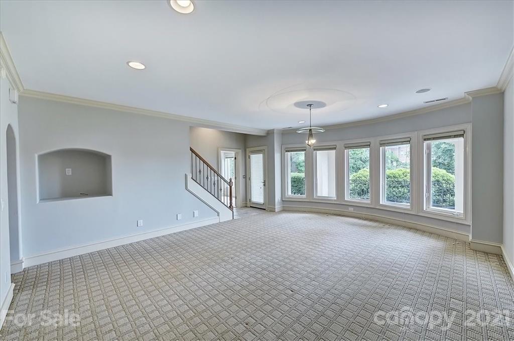 17519 Jetton Road, Unit 390 Cornelius, NC 28031 - Photo 21 of 31 a view of an empty room with a window and wooden floor