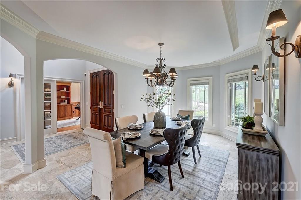 17519 Jetton Road, Unit 390 Cornelius, NC 28031 - Photo 5 of 31 a view of a dining room with furniture and chandelier