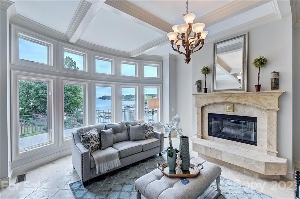 17519 Jetton Road, Unit 390 Cornelius, NC 28031 - Photo 7 of 31 a living room with furniture a chandelier and a fireplace