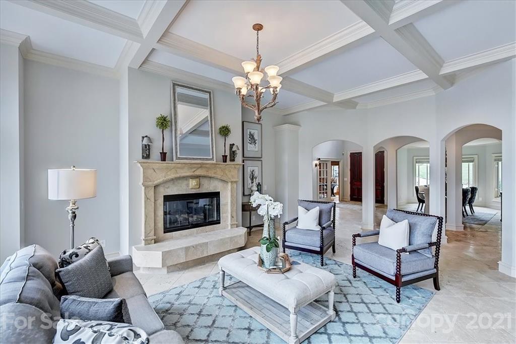 17519 Jetton Road, Unit 390 Cornelius, NC 28031 - Photo 8 of 31 a living room with furniture a chandelier and a fireplace