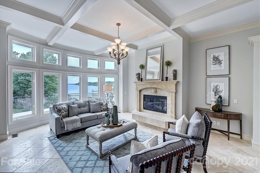 17519 Jetton Road, Unit 390 Cornelius, NC 28031 - Photo 9 of 31 a living room with furniture a chandelier and a fireplace