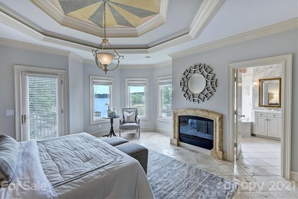 17519 Jetton Road, Unit 390 Cornelius, NC 28031 - Photo 10 of 31 a bedroom with a bed and a fireplace