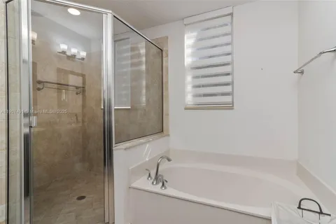 a bathroom with a bathtub and a shower